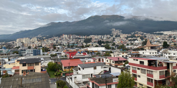 Town in Ecuador framed by a mountain range.